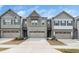 Charming townhome exterior with stone accents, neutral siding, and a two-car garage, set in a well-maintained neighborhood at 2129 Mars Hill Ln, Apex, NC 27502