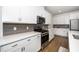 Well-equipped kitchen with stainless steel gas range, microwave, white cabinets, and gray subway tile backsplash for a modern touch at 2129 Mars Hill Ln, Apex, NC 27502