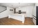Modern kitchen with white cabinets, a center island, and stainless steel appliances at 2129 Mars Hill Ln, Apex, NC 27502