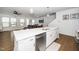 Bright, open kitchen with a large island, stainless steel appliances, and pendant lighting at 2129 Mars Hill Ln, Apex, NC 27502