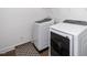 Bright laundry room featuring a modern washer and dryer on wood-look flooring at 2129 Mars Hill Ln, Apex, NC 27502