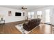 Cozy living room featuring hardwood floors, a comfortable recliner, and natural light at 2129 Mars Hill Ln, Apex, NC 27502