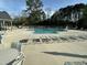 Community pool surrounded by lounge chairs, perfect for relaxation and recreation at 2129 Mars Hill Ln, Apex, NC 27502