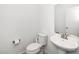 Neat powder room with a pedestal sink, modern toilet, and a large mirror, offering a clean and functional space at 2129 Mars Hill Ln, Apex, NC 27502
