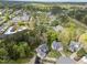 Aerial view of a home and neighborhood surrounded by green trees at 213 Lewiston Ct, Cary, NC 27513