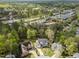 An aerial view of a home and neighborhood surrounded by lush green trees at 213 Lewiston Ct, Cary, NC 27513