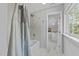 Bright bathroom with a tub and shower combination and a convenient exterior view at 213 Lewiston Ct, Cary, NC 27513