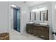Bright bathroom features a double vanity, tile floor, and glass-enclosed shower at 213 Lewiston Ct, Cary, NC 27513