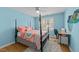Inviting bedroom featuring a four-poster bed, plush rug, and light blue painted walls at 213 Lewiston Ct, Cary, NC 27513