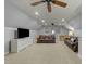 Spacious bonus room with vaulted ceilings, neutral carpet, and leather couches at 213 Lewiston Ct, Cary, NC 27513
