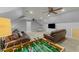 Spacious bonus room with hardwood floors, ceiling fans, and game table at 213 Lewiston Ct, Cary, NC 27513