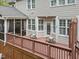 A spacious deck with chairs and pillows featuring a screened porch attached to the house at 213 Lewiston Ct, Cary, NC 27513