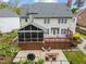 A tiered wooden deck with screened in porch featuring backyard seating at 213 Lewiston Ct, Cary, NC 27513