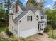 Expansive two-story home with a brick chimney, an attached garage and mature trees at 213 Lewiston Ct, Cary, NC 27513