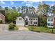 Charming two-story home with a well-manicured lawn, mature trees and a circular driveway at 213 Lewiston Ct, Cary, NC 27513