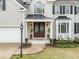 Elegant home featuring a beautiful front entrance with a detailed doorway and manicured landscaping at 213 Lewiston Ct, Cary, NC 27513