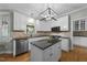Well-lit kitchen featuring white cabinets, stainless steel appliances, and a center island at 213 Lewiston Ct, Cary, NC 27513
