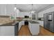 Modern kitchen with white cabinets, granite countertops, and stainless steel appliances at 213 Lewiston Ct, Cary, NC 27513