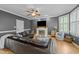 Cozy living room with dark leather couch, white brick fireplace, ceiling fan, and shutters on the windows at 213 Lewiston Ct, Cary, NC 27513