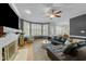 Comfortable living room with dark leather couch, white brick fireplace, and shutters on the windows at 213 Lewiston Ct, Cary, NC 27513