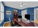 Comfortable office featuring blue painted walls, white trim, and built-in shelving at 213 Lewiston Ct, Cary, NC 27513