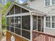 An exterior view of a screened-in porch featuring curtains and string lights at 213 Lewiston Ct, Cary, NC 27513