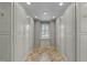 Large walk-in closet with custom shelving and storage throughout, along with natural light from the window at 213 Lewiston Ct, Cary, NC 27513