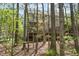 Exterior back view of home featuring a deck, screened in porch, and natural wooded views at 22 Lure Ct, Durham, NC 27713