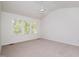 Bedroom features neutral carpet, a ceiling fan, and a large window at 22 Lure Ct, Durham, NC 27713