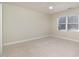 A bright bedroom with neutral walls, carpet, a ceiling fan and a single window at 22 Lure Ct, Durham, NC 27713