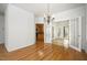 Dining area with hardwood floors, chandelier, and french doors that lead into the sunroom at 22 Lure Ct, Durham, NC 27713