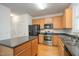 Modern kitchen with stainless steel appliances, an island, and wooden cabinetry at 22 Lure Ct, Durham, NC 27713