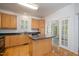 Kitchen with a center island, granite countertops, wooden cabinetry, and hardwood floors at 22 Lure Ct, Durham, NC 27713