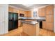 Updated kitchen with stainless steel appliances, center island, and hardwood flooring at 22 Lure Ct, Durham, NC 27713