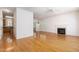 Open-concept living space featuring hardwood flooring, a fireplace, and an elegant chandelier at 22 Lure Ct, Durham, NC 27713