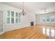 Bright living area featuring hardwood floors, a fireplace, and large shuttered windows at 22 Lure Ct, Durham, NC 27713