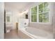 Bright main bathroom with a large tub and window at 22 Lure Ct, Durham, NC 27713