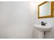 Small powder room featuring a pedestal sink and a gold-framed mirror at 22 Lure Ct, Durham, NC 27713