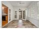 Bright sunroom with tile flooring and glass doors leading to an outdoor porch at 22 Lure Ct, Durham, NC 27713