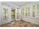 Sunroom featuring tile floors, white trim, and inviting access to the outdoors at 22 Lure Ct, Durham, NC 27713