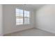 Cozy bedroom with plush carpeting and a large window offering a neighborhood view at 2318 Sugar Cone Way, Fuquay Varina, NC 27526