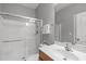 Bathroom featuring a glass-enclosed shower, white vanity, and neutral walls, creating a clean aesthetic at 232 Vinewood Pl, Holly Springs, NC 27540