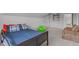 Bright attic bedroom featuring a comfortable seating area, natural light, and neutral decor at 232 Vinewood Pl, Holly Springs, NC 27540