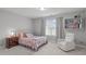 Bright bedroom featuring a cozy chair, window, closet, and neutral decor at 232 Vinewood Pl, Holly Springs, NC 27540