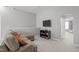 Cozy bonus room featuring a comfortable seating area and entertainment center at 232 Vinewood Pl, Holly Springs, NC 27540