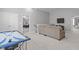 Spacious bonus room with an air hockey table, comfortable seating, and multiple entryways at 232 Vinewood Pl, Holly Springs, NC 27540