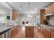 Spacious kitchen with a granite island, stainless steel appliances, ample cabinet space, and hardwood floors at 232 Vinewood Pl, Holly Springs, NC 27540
