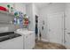 Functional laundry room with shelving, washer, dryer, and convenient access to exterior at 232 Vinewood Pl, Holly Springs, NC 27540