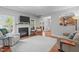 Spacious living room with a fireplace, comfortable seating, and an open view to the kitchen at 232 Vinewood Pl, Holly Springs, NC 27540