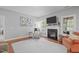 Comfortable living room features a cozy fireplace, plush seating, and a neutral color palette at 232 Vinewood Pl, Holly Springs, NC 27540
